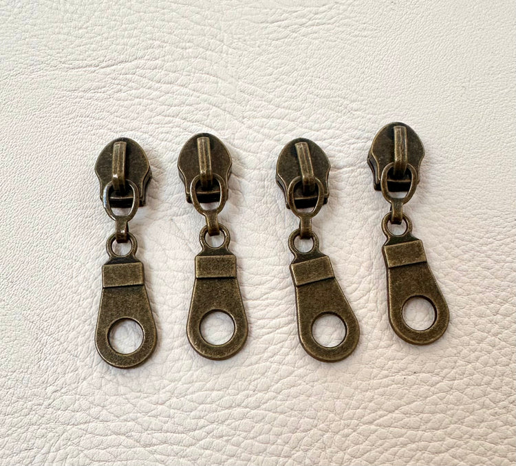 Set of 4 #5 donut zipper pulls in antique