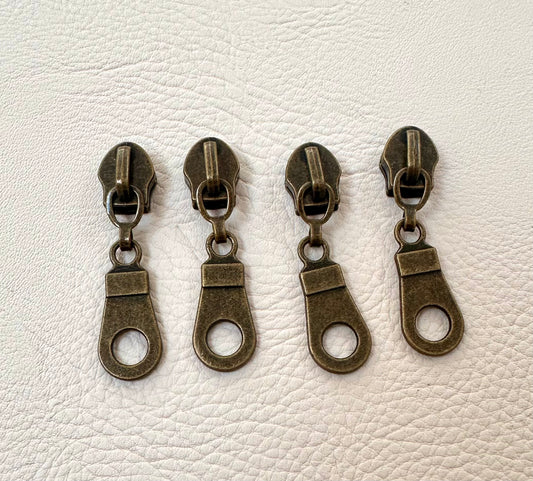 Set of 4 #5 donut zipper pulls in antique